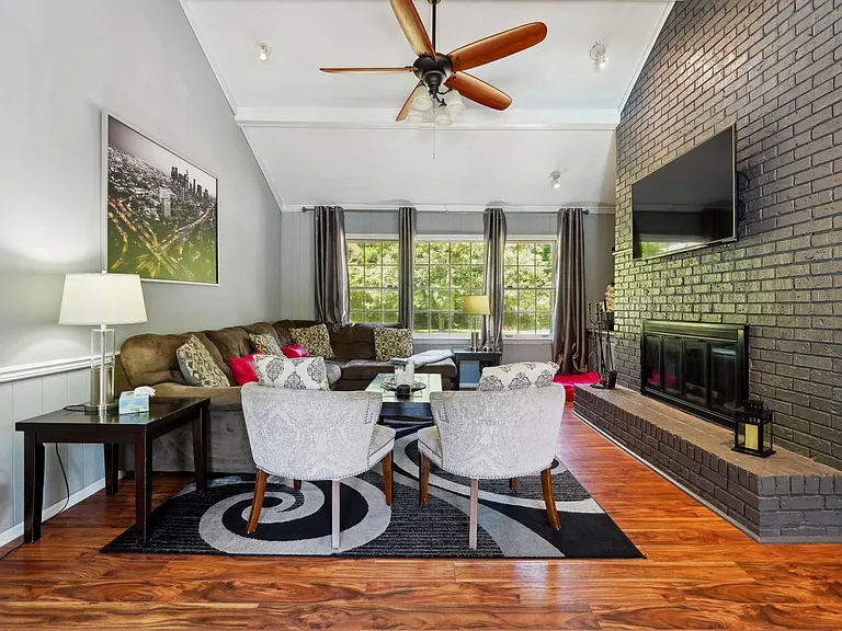 Living Room with TV, Fireplace & access to Garage & Upper Back Patio -Main Level