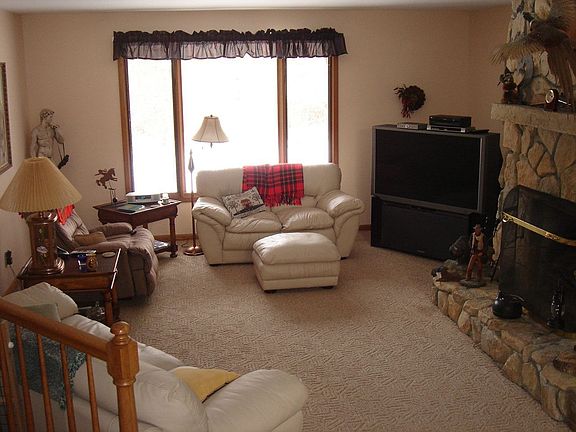 Come home to comfort in the step-down great room with warm stone fireplace.