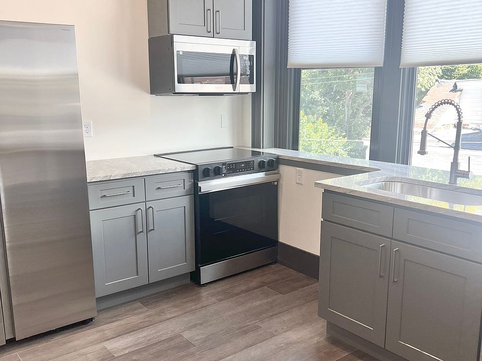 iPhone update of the kitchen with microwave and shades.