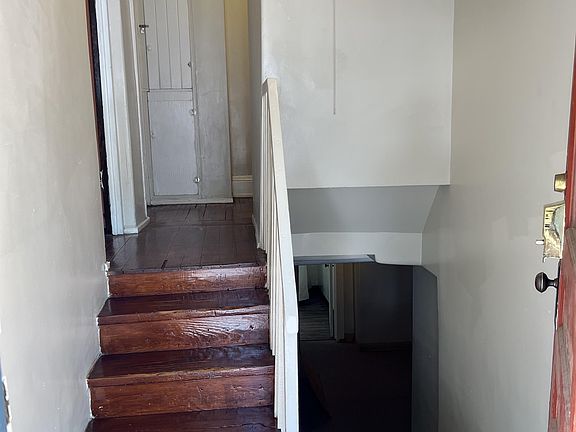 Entry - Stairs lead up to kitchen/living; stairs leading down to bedrooms, bathroom, utility