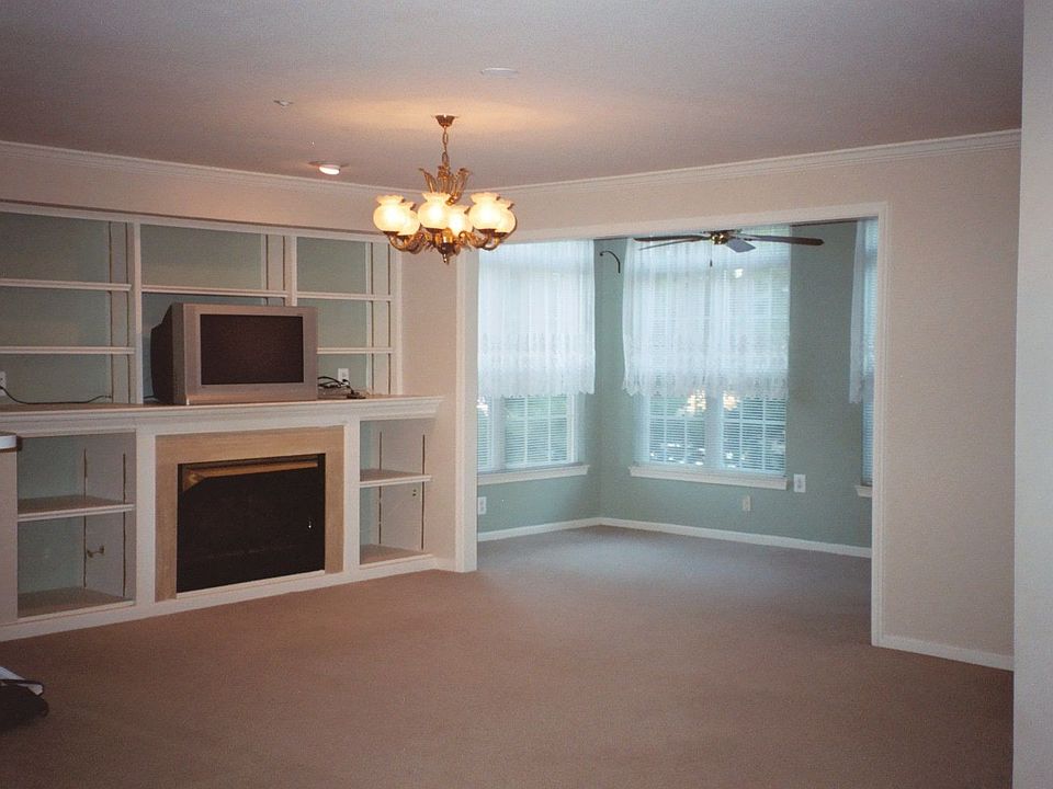 Living room looking into Sun room; light fixture replaced with ceiling fan