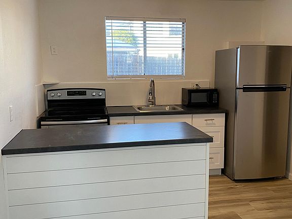 New Cabinets, Countertops, Electric range, sink and refrigerator