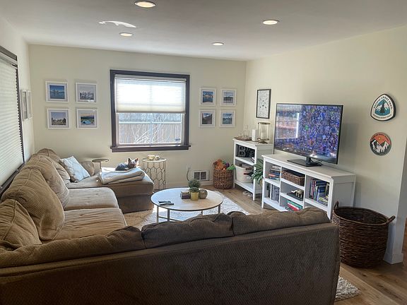 Large living room with an open concept into the kitchen. Plenty of natural light and new flooring throughout