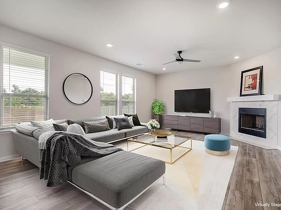 Expansive living room featuring a cozy fireplace and large windows that flood the space with natural light.
