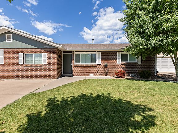 Front door with detached garage to the right