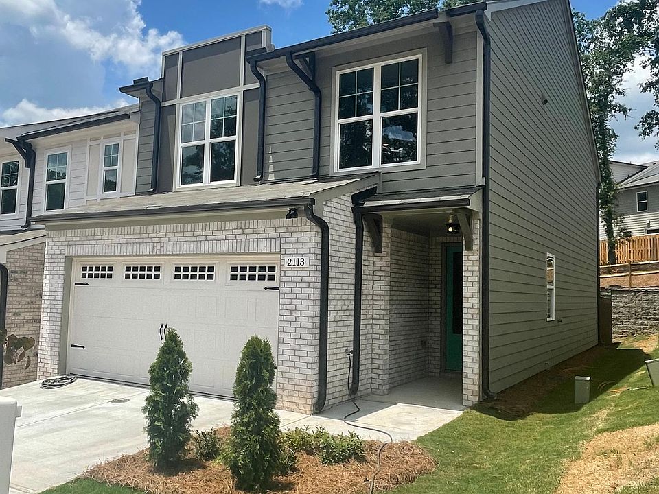 Townhome elevation with 2 car garage and brick front end unit