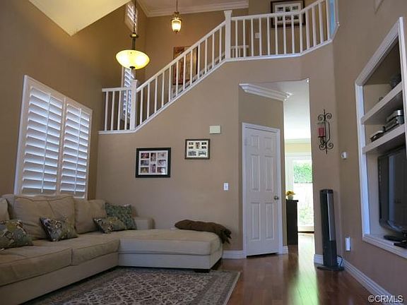 Living room with Vaulted Ceiling, wood floor thru-out, and plant