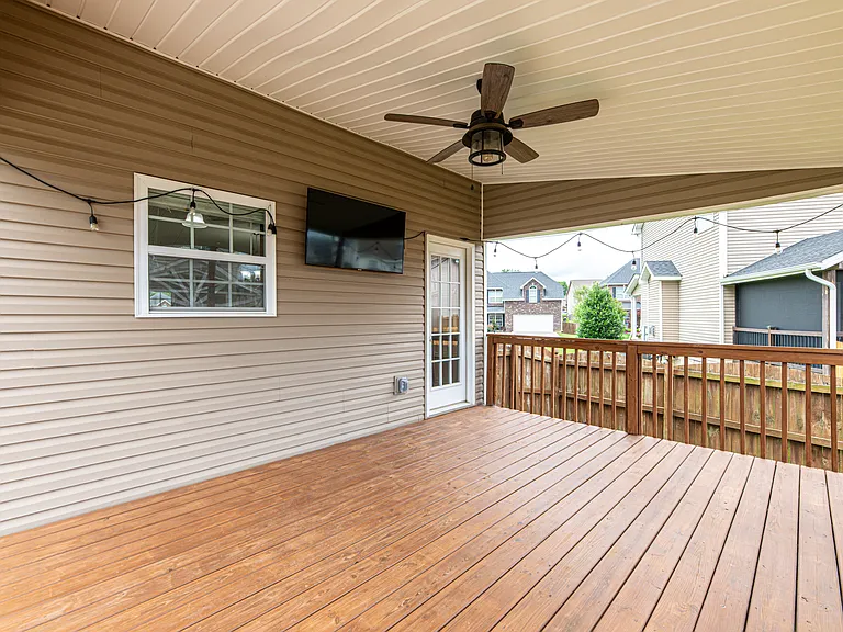 Relax in a fully fenced-in backyard designed for entertaining. The upper deck steps down to a dedicated concrete pad perfect for grilling. Unwind in the evening under the cozy string lighting or watch the game on the outdoor tv