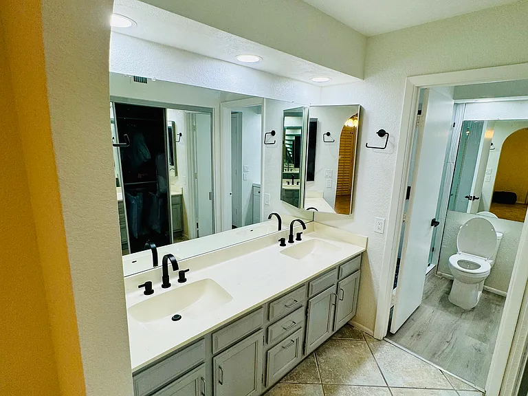 Downstairs Master bedroom separate double sinks and walk-in closet