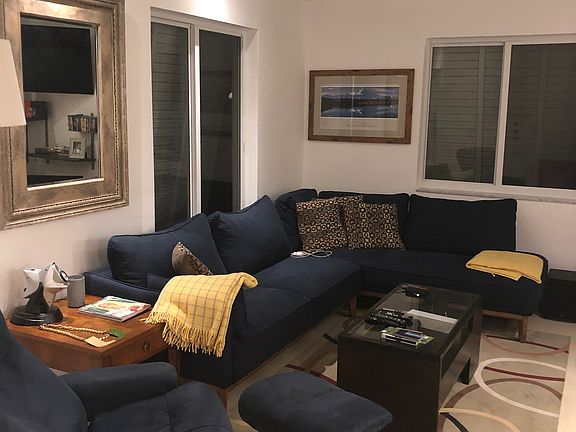 living room comes partially furnished with L shape couch and coffee tale