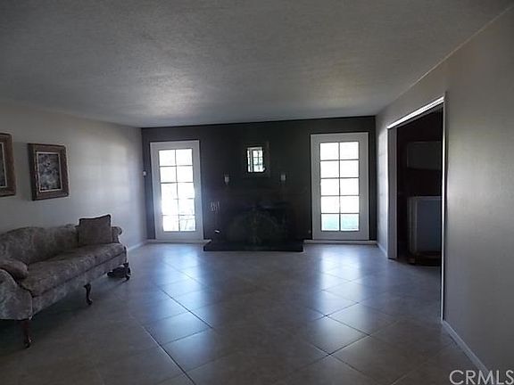 Formal living room.  French windows.  Formal dining to the right.