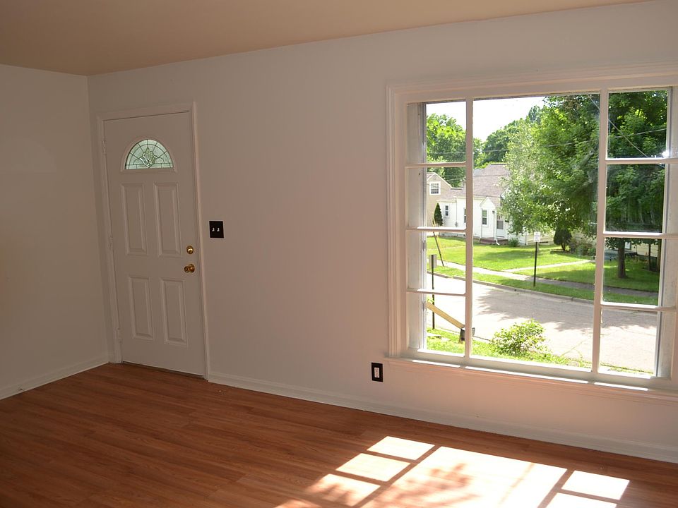 Front door and living room with a picture window view of the street