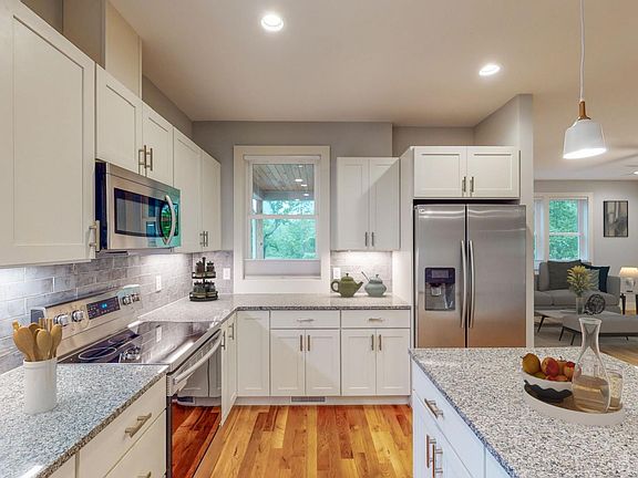 Modern appliances including stainless refrigerator with water and ice dispenser in door.