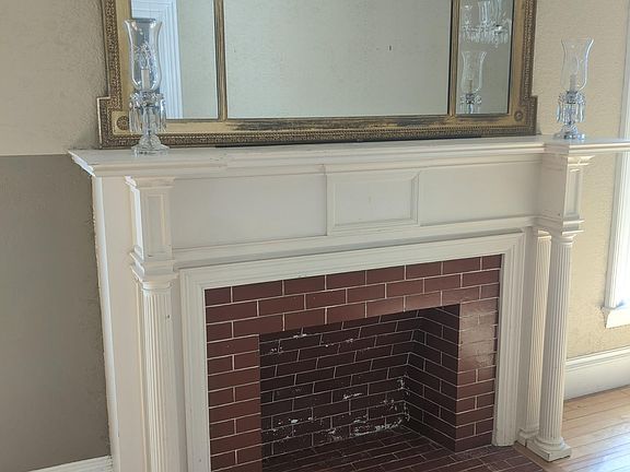Period fireplace and mantel mirror in parlor