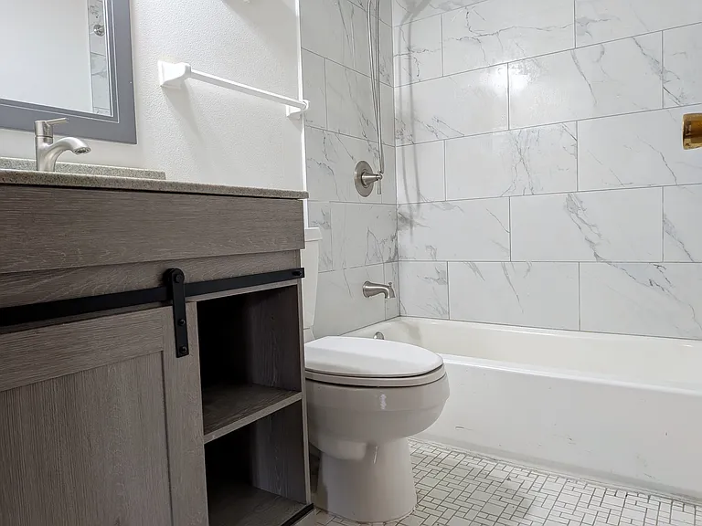 Another view of the main bath with a new stylish vanity