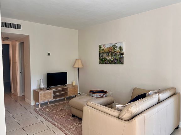 family room with Smart TV. Leather sofa.