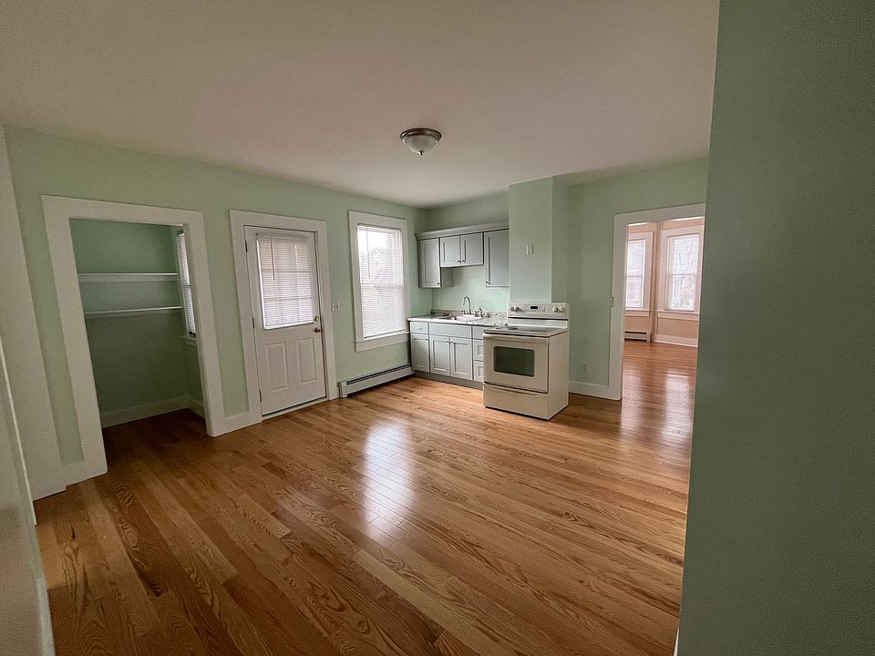 Large eat-in kitchen, flat top stove, oven, refrigerator.