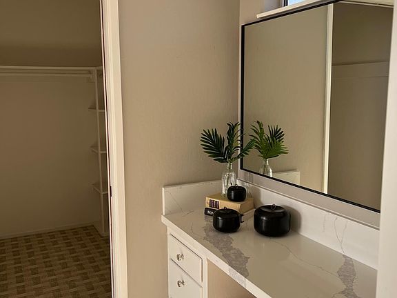 Vanity area with walk in closet