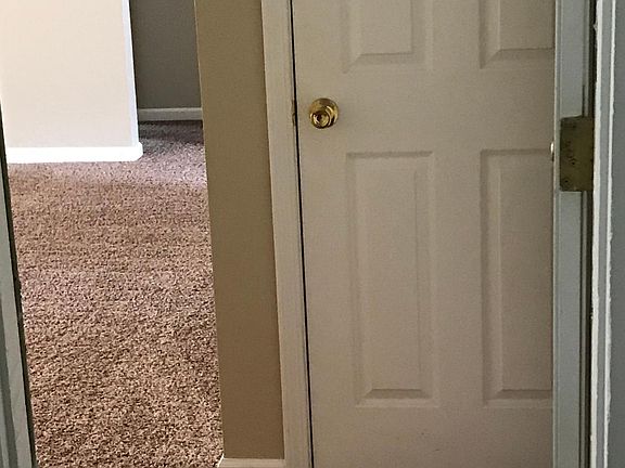 View from front door entrance, showing coat closet and entry into living room.