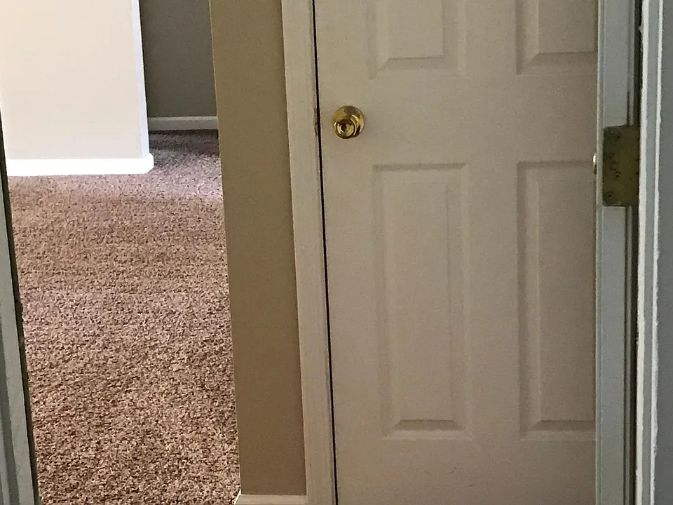 View from front door entrance, showing coat closet and entry into living room.