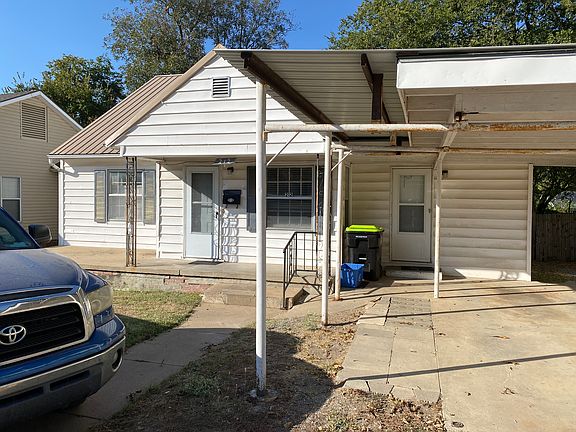front of house showing carport as well