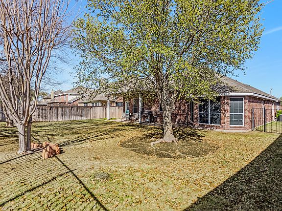Back of property with a patio area, brick siding, and a fenced backyard