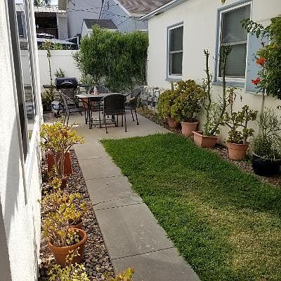 Enjoy the yard with potted plants right outside your door.