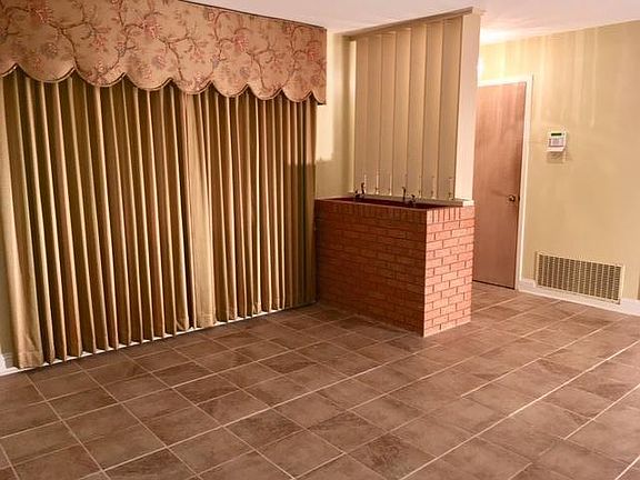 Front living room, Custom gold-toned draperies closed, Beautiful brick enclosed plantar, Foyer closet upon entering, ADT alarm ready