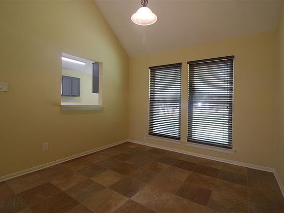 Dining has a pass-thru bar to kitchen and windows provide natural light.