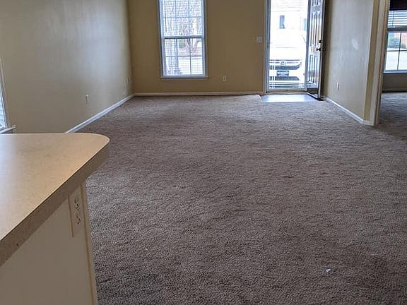 View from kitchen toward the front door. There is a full view storm door.