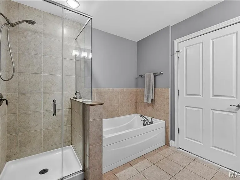 Large glass shower and tub in primary bathroom