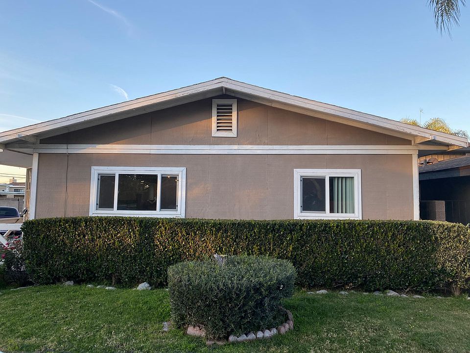 Living room window (left) faces front yard and street. Home entrance is to the left.