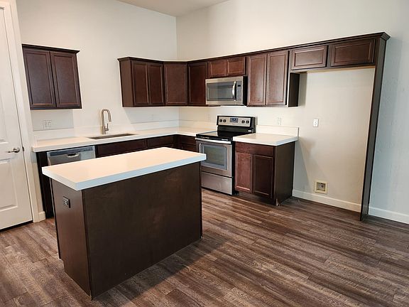 Kitchen which now has a stainless refridgerator.