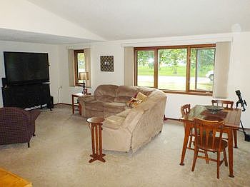 Spacious Living Room with newer carpet and plenty of natural light.
