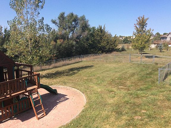 Fenced in backyard, playset