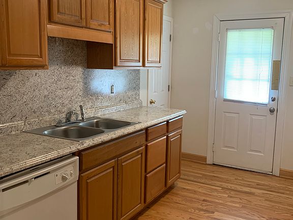 kitchen with dishwasher, showing entry to pantry and door to side yard