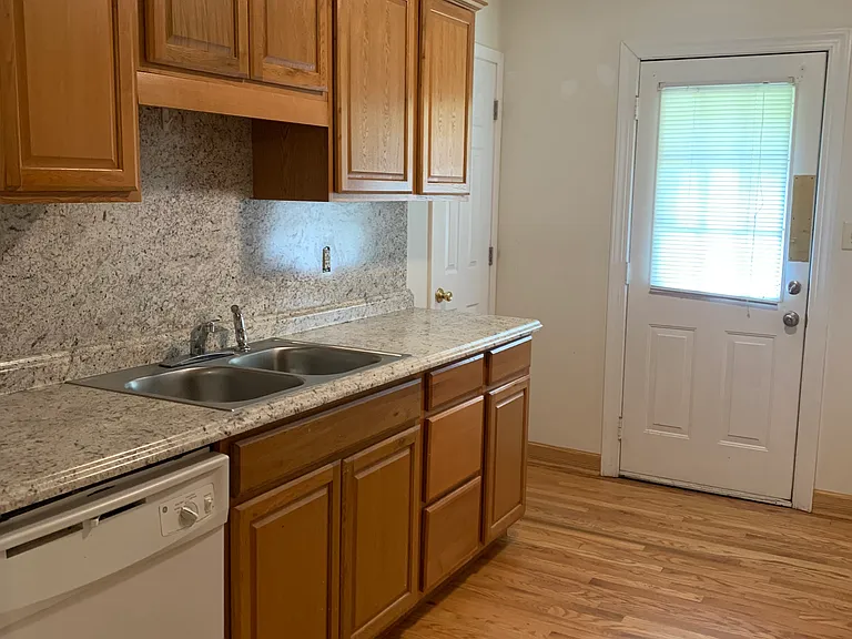 kitchen with dishwasher, showing entry to pantry and door to side yard