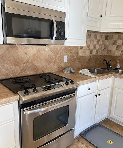 Electric stove, microwave, can see corner sink to the right