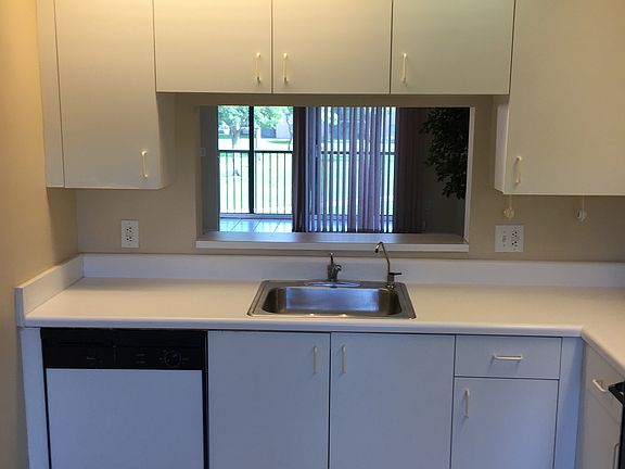 Kitchen features refrigerator, new tile and breakfast nook.