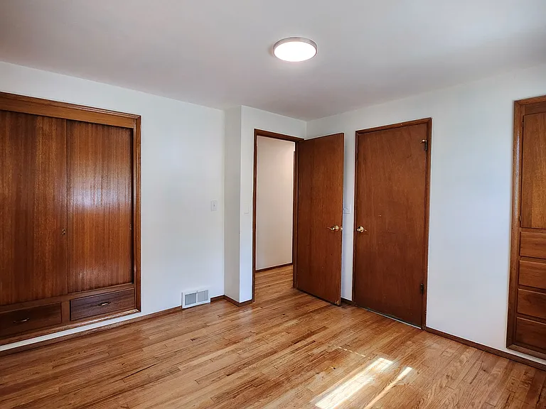 Primary suite has two built-ins and an attached 1/2 bathroom. Located at the rear of the home for peace and quiet. Overlooks the side yard.