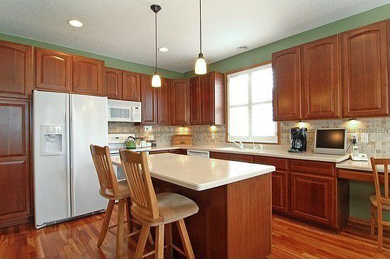 Cherry cabinets, cherry floor, and corian countertops.  Wow, what a kitchen!