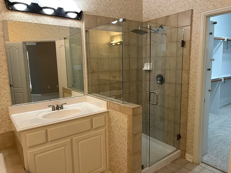 Primary bathroom with split vanities.