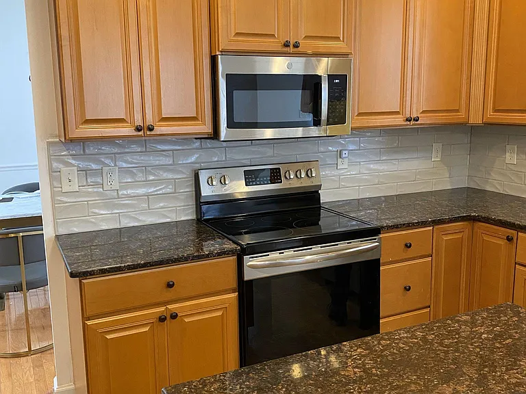 Closer View of Kitchen Cabinets, Granite Countertops and Tile Backsplash
