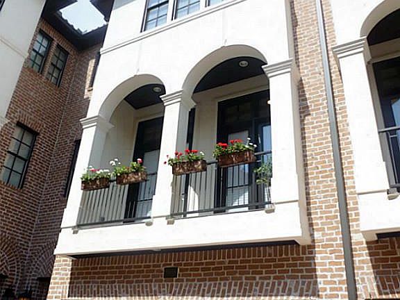 Mediterranean style home in the Medical Center area with a front balcony.