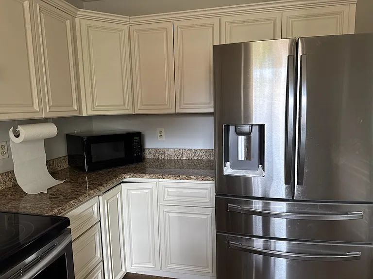 Updated kitchen with stainless steel appliances and granite countertops. New floors to be installed by 10 July.
