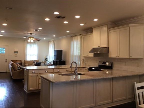 Kitchen is spacious with plenty of cabinet space and beautiful granite counter tops.  Cabinets are wood with soft close.