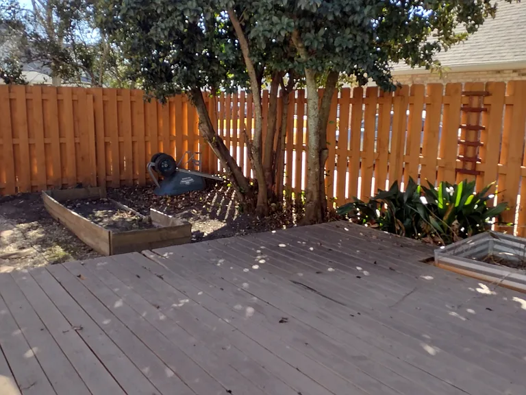 Fenced Back Corner, adjacent driveway