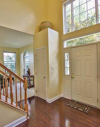 Bright 2- story foyer boasts new flooring