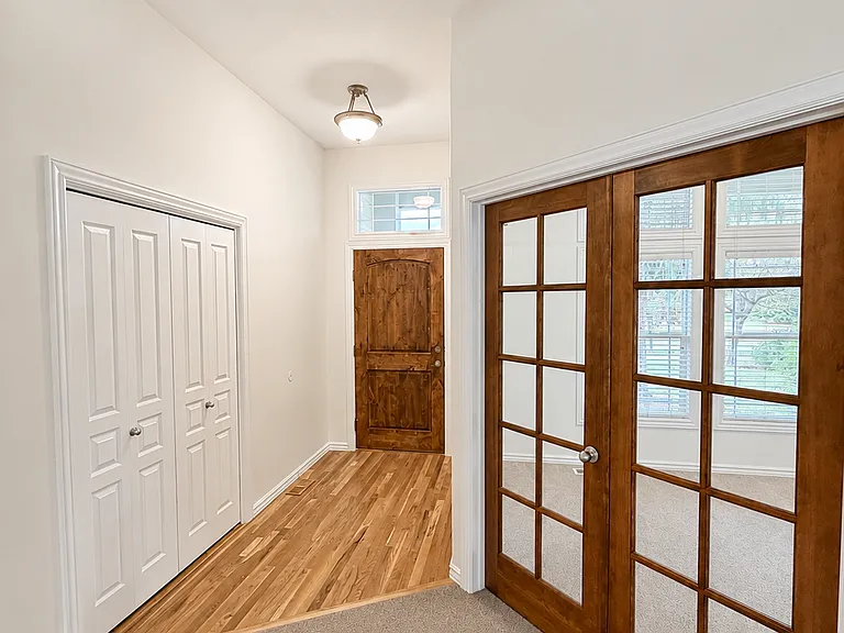 Interior front entry with closet. French doors to office/den.
