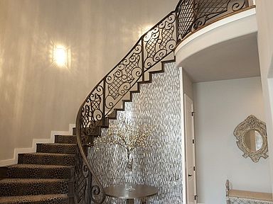 Amazing sweeping staircase in foyer